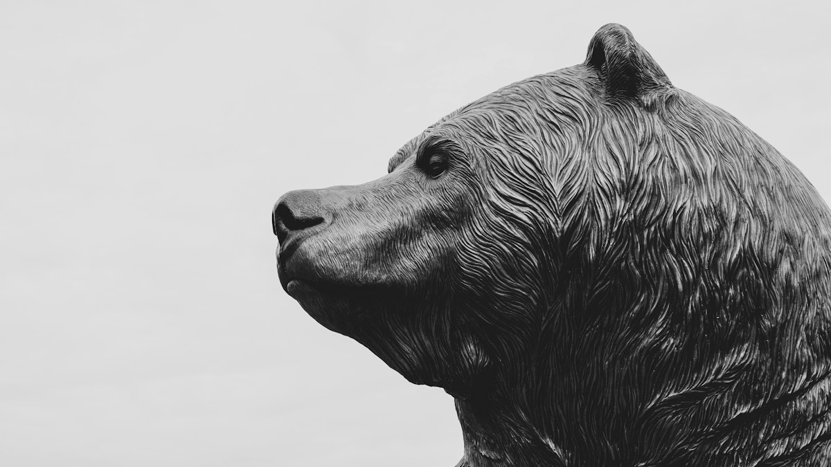 A bronze statue of a bear seen in profile
